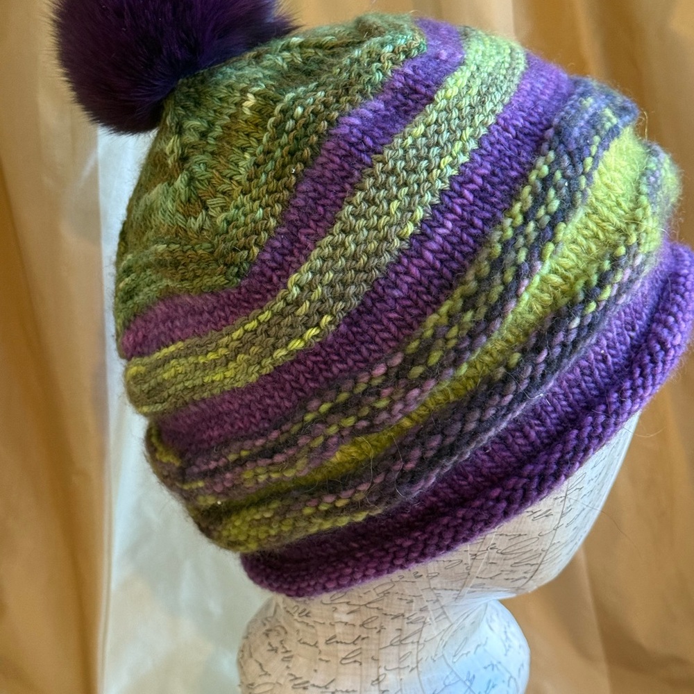 Winter hat with pom pom. Hand knitted.  A blend of wool and silk yarns.